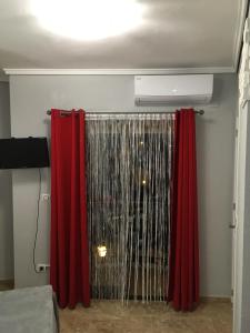 a room with red curtains and a heater at Denia Playa I in Denia +16 photos