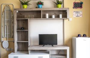 a television on a wooden shelf in a room at Lucky 2 in Paralimni