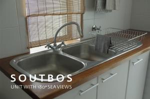 a stainless steel sink in a kitchen with a window at Soutbos & Janfrederik in Agulhas +43 photos