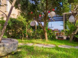 a garden with paper lanterns and a rock at Kounopetra Beach Luxury Villas in Kounopetra