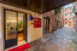 an empty alley with a door in a building at Hotel San Giorgio in Venice