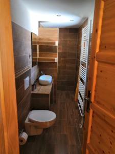 a small bathroom with a toilet and a sink at Chata Sipkova I in Terchová