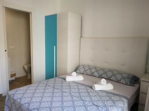 a bedroom with a bed with two towels on it at Apartamentos Benidorm Chorrol in Benidorm