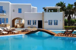 a swimming pool in front of a villa at Chora Resort Hotel & Spa in Chora Folegandros