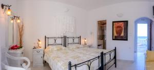 a bedroom with a large bed in a room at Vardia Bay Studios in Karavostasi