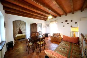 a living room with a table and a couch at Cascina Delle Rose in Barbaresco