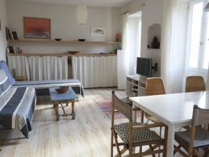 a living room with a bed and a table and chairs at Chez Renée in Banyuls-sur-Mer