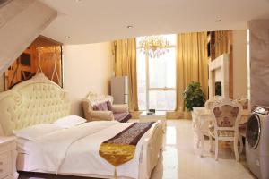 a bedroom with a large white bed and chairs at Guangzhou Ba Dun Hotel - Beijing Road in Guangzhou