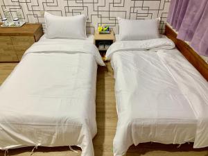 Postel nebo postele na pokoji v ubytování Fu Hwa Homestay