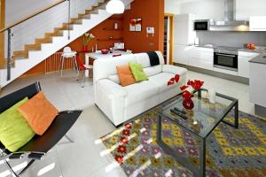 a living room with a white couch and a glass table at Salobre Vista Golf 19 in Maspalomas