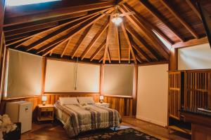 a bedroom with a bed and a ceiling at Espaço Tajj in São Roque