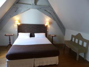 a bedroom with a large bed and a chair at Résidence Charles Quint in Besançon