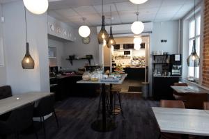 a restaurant with a table in the middle of a room at Livin Station Hotel in Örebro