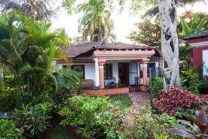 a small house with a garden in front of it at Villa Sunflower in Cavelossim
