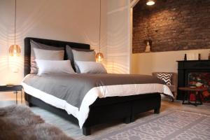 a bedroom with a large bed and a fireplace at Exklusive Designferienwohnung The Backyard TBY 02 in Trier