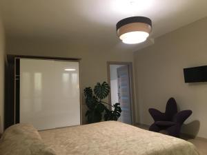 a bedroom with a bed and a light at Home Holiday "Da Mamma" in Alba