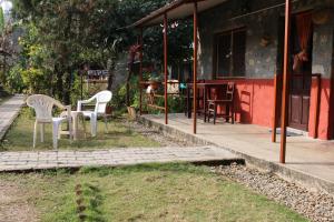 two chairs and a table in front of a house at Gurkha Lodge in Pokhara