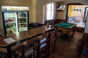 a restaurant with a bar with a pool table at Element Riders Place Backpackers in Lüderitz