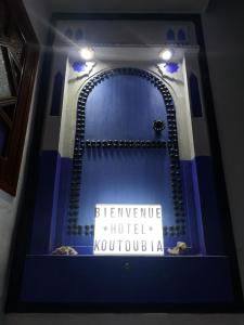 a bathroom with a mirror with a sign that reads beyonne hotel kuch at Hôtel Koutoubia in Chefchaouen