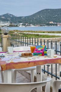 a table with food and drinks on top of a balcony at Peramos Rent House in Néa Péramos