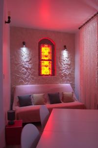 a living room with a couch and a red light at Le Moulin de PEBRE in La Ciotat