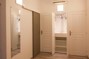 a bathroom with a sink and a mirror at Le Moulin de PEBRE in La Ciotat