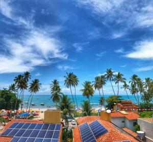 a group of solar panels on the roofs of a resort at Pousada Paraíso Maragogi in Maragogi