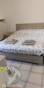 a bedroom with a bed and a table with dishes at Casa della Sala Spada in Casale Monferrato