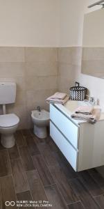 a bathroom with a toilet and a sink at Casa della Sala Spada in Casale Monferrato +13 photos