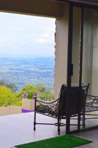 a bench sitting on the porch of a house at Rehoboth Mountain Suites in Mbabane