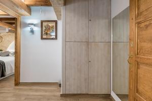 a white refrigerator in a room with wood floors at Hostal 977 in Tarragona