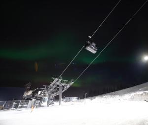 a person riding a ski lift in the snow at night at Narvik Adventures AS in Narvik