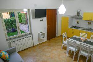 a kitchen and dining room with a table and chairs at esiloM Aparthotel in Cantalupo nel Sannio