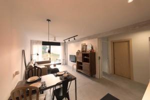 a living room with a table and a dining room at Green Views Benalmadena in Benalmádena