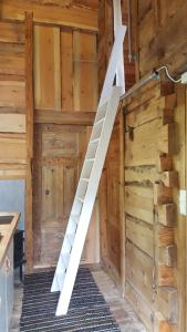 a white staircase in a room with wooden walls at Tiny house with Fjordview! in Lauvstad