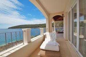 a balcony with a view of the ocean at Villa Putto in Vela Luka