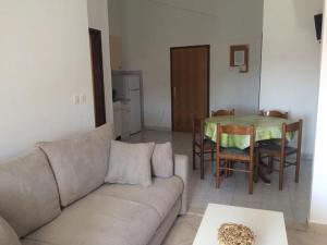 a living room with a couch and a table at Apartments Paladina in Mandre