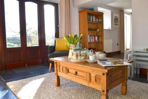 a living room with a wooden coffee table at Petrock Holiday Cottages in Newton Saint Petrock