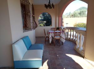 Una sala de estar con un sofá azul y una mesa. en Villa Silvia, en Ágios Matthaíos