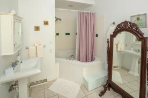 a bathroom with a sink, toilet and bathtub at Cloran Mansion Bed & Breakfast in Galena