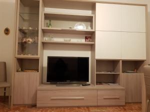 a large entertainment center with a flat screen tv at Luisa Appartamento Lunigiana in Cinque Terre in Ceparana