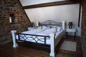 una camera da letto con letto, lenzuola e cuscini bianchi di Landhaus am Aremberg / Eifel ad Antweiler