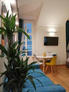 a living room with a blue couch and a table at SERENDIPITY Porta Palatina 3(Centro Storico)TORINO in Turin +17 photos