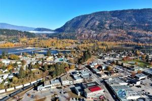 an aerial view of a town with a mountain at Chameleon Hotel in Castlegar