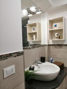 a bathroom with a sink and a mirror at SERENDIPITY Porta Palatina 3(Centro Storico)TORINO in Turin