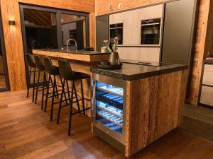 a kitchen with a bar with a wine cellar at Chalet See Tirol - Ischgl/Kappl in See