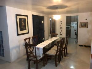 a dining room with a table and chairs at Casa Blumenau in Blumenau