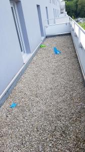 a balcony with rocks and blue items on the floor at Private room CDG airport Parc Expo in Villepinte