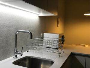a kitchen with a dish drying rack over a sink at Welcome inn Viseu in Viseu