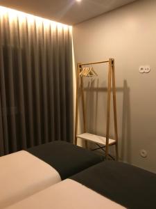 A bed or beds in a room at Welcome inn Viseu
